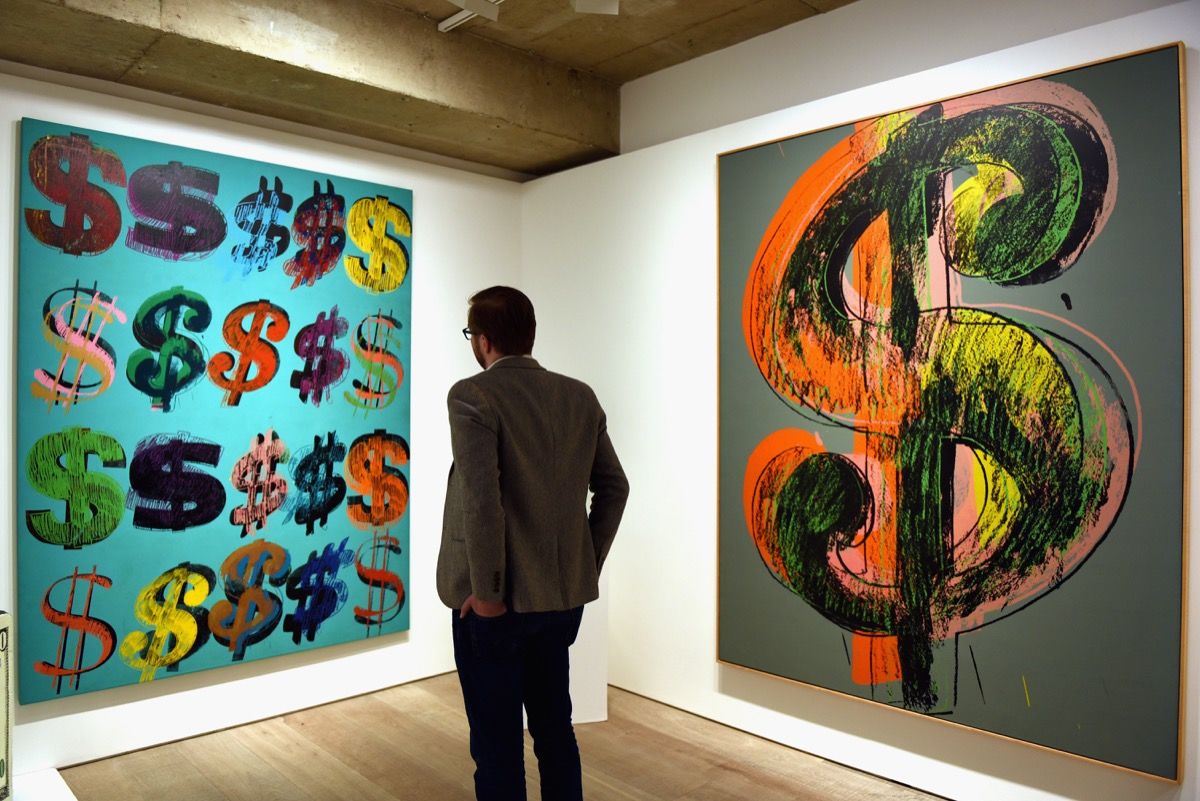 A visitor studies Andy Warhols ‘Dollar Signs’ in Sotheby’s London showroom